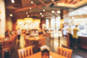 Restaurant interior with customer and wood table blur abstract background with bokeh light photo