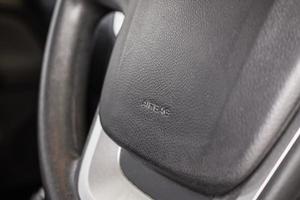 Safety airbag sign on car steering wheel photo