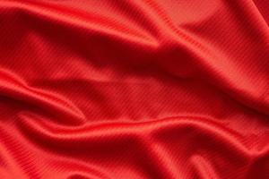 Red sports clothing fabric football jersey texture close up photo