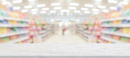 marble table top with supermarket grocery store blurred background with bokeh light for product display photo