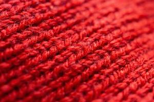 Fondo de textura de tejido de lana de punto rojo closeup foto