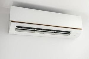 Air conditioner on white wall room interior background photo