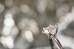 anillo de diamantes de compromiso de lujo en caja de regalo de joyería con fondo de luz bokeh foto