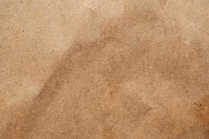 Brown crumpled paper recycled kraft sheet texture background photo