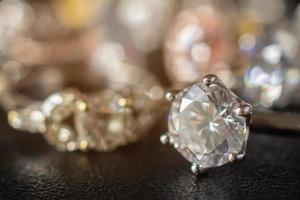 Jewelry diamond rings set on black background close up photo