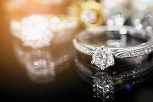 Jewelry diamond rings with reflection on black background photo