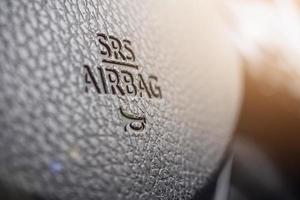 Safety airbag sign on car steering wheel with horn icon photo