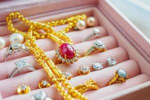 Gold and silver diamond gemstone sapphire ring necklaces and pearl earrings in luxury jewelry box photo