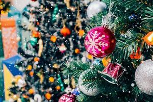 Decorated Christmas tree with colorful bauble on sparkling bokeh light blurred background photo