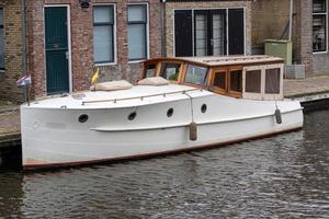 boat on the river with old house in the background photo