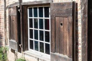 window with shutters on the wall photo