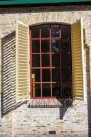 window with shutters on the wall photo