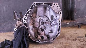 Manual Transmission case assy car that is being repaired, looks dirty and dusty photo