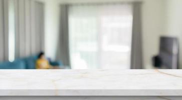 Empty marble table top with blur room interior with window curtain background photo