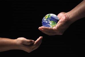 environmental protection concept The world for the future. globe in hand passed to the other photo