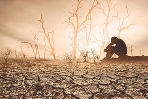 concept of global warming and drought People sat mourning over the drought. A world without water and food shortages. water and food crisis photo