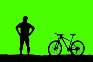 silhouette of a person riding a bike photo