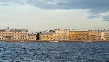 the city's river canal and a view of the historic beautiful buildings on the embankment at sunset.river ships with tourists sail in a pity. photo