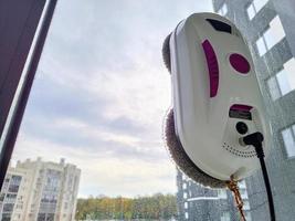 Vacuum cleaner robot washing glass window. Robot window cleaner photo