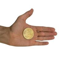 Bitcoin token in man's hand isolated on white background photo