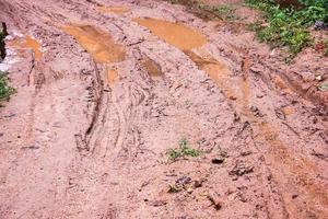 Tire tracks on a muddy road. photo