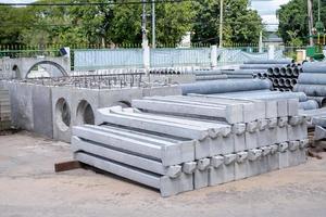 Precast concrete pillars, neatly arranged in a building material shop, prefabricated cement pillars photo