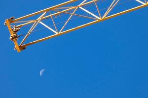 Moon during the day with blue sky photo