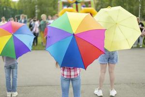 Colored umbrellas in children. Performance on street. Children's holiday. photo