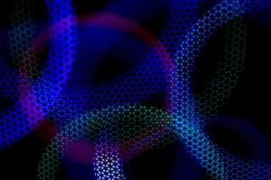 Color music. Abstract background glows in dark. Circles in net. photo