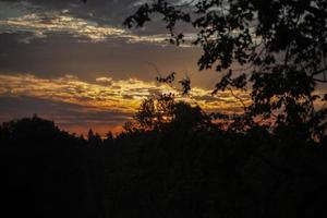 Sunset. Dawn in morning. Warm light in sky. Heavenly landscape in village. photo