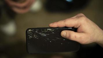 Smashed smartphone screen. Phone in hand. Broken gadget. photo