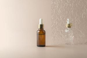 A face serum or essential oil in a brown dropper bottle standing on a beige background photo