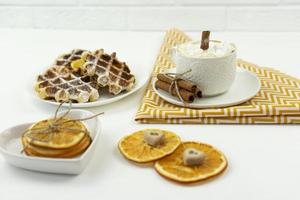 A tasty breakfast with waffles and coffee standing on a table photo