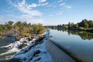 Beautiful Idaho waterfall meeting snake river near temple with sky in background photo