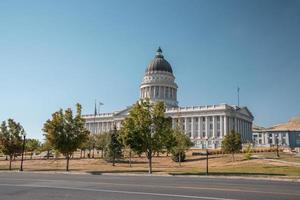 Empty road by State Capitol building with clear blue sky in background in summer photo