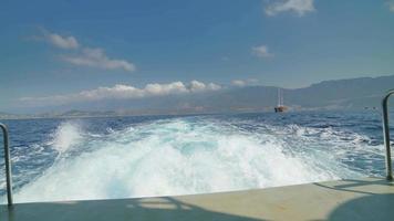 8K White sparkling waters behind a fast boat in the sea video