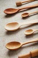 Wooden spoons made of natural wood on burlap fabric as a craft. photo