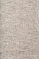 Textured background of fabric from burlap fibers with fibers in full screen photo