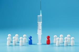 Contradictions of different opinions of a red and blue man about vaccination in a syringe in the center, on a blue background photo