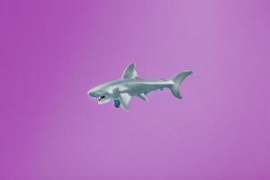 Toothy shark toy on a pink background with free space. photo