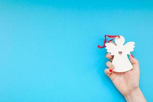 Woman hand holding homemade wooden christmas toy photo