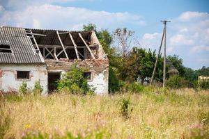 Abandoned farm house in a field photo