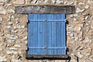 House facade with blue shutters in France photo