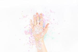 Pearl pastel confetti sparkles with woman hand photo
