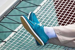 Legs in pants and bright blue topsiders on yacht photo