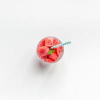 Crushed watermelon in glass on white background photo