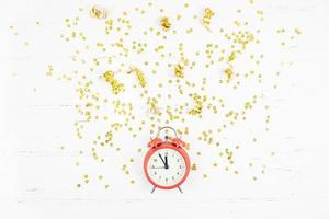 New Year composition alarm clock golden confetti photo