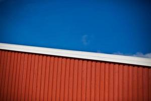 Geometrical shot of house wall on sky background photo