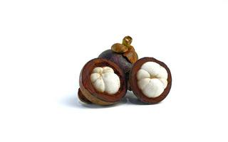 Mangosteen and cross section showing the thick purple skin and white flesh of the queen of friuts, on white background photo