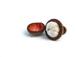 Mangosteen and cross section showing the thick purple skin and white flesh of the queen of friuts, on white background photo